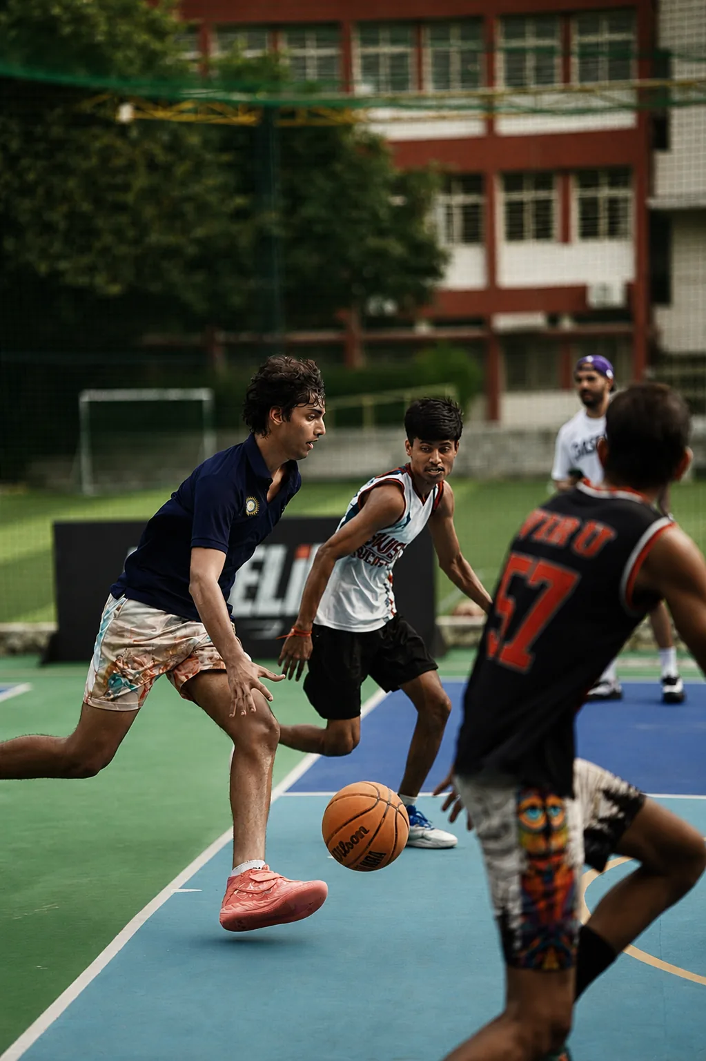 A Baseline player applying ball control during live basketball action